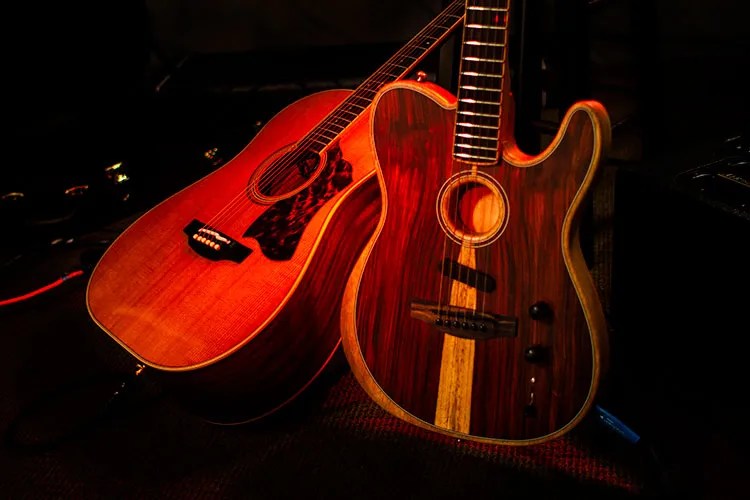 an acoustic guitar and an electric guitar