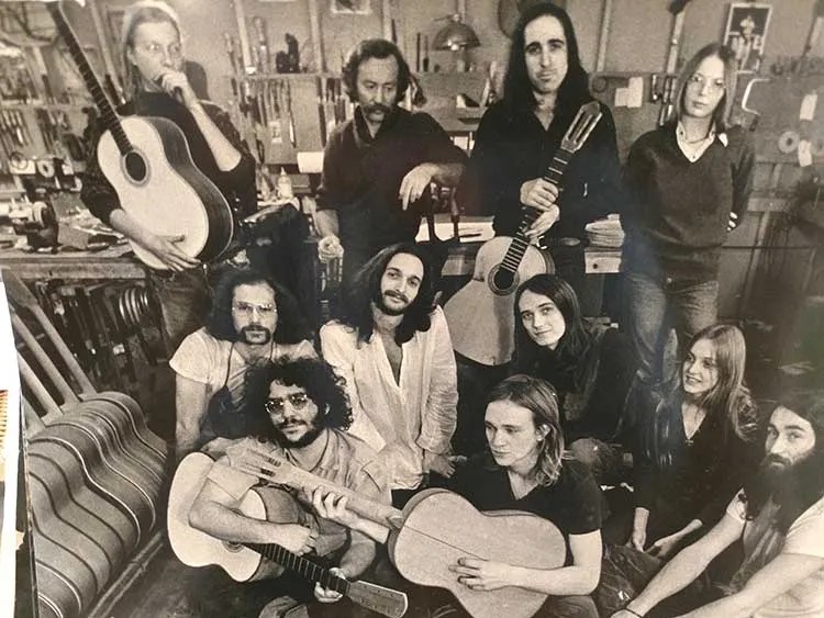 Michael Gurian (standing center with guitar) and his shop workers in the late 1960s.