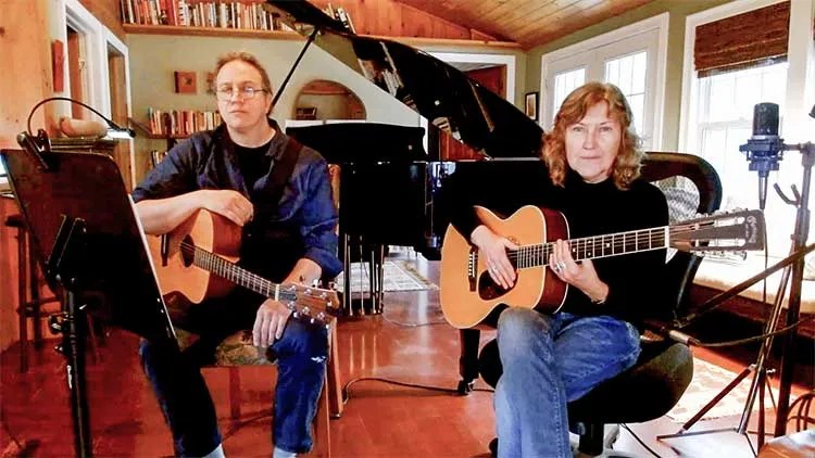 Jane Miller and Brian Parent playing duets on acoustic guitars