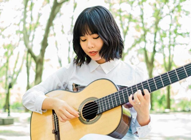 Jiji playing classical guitar