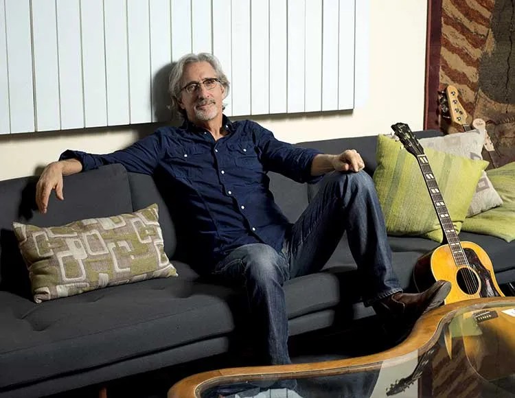 John-Leventhal-on-couch-with-acoustic-guitar-credit-Wes-Bender