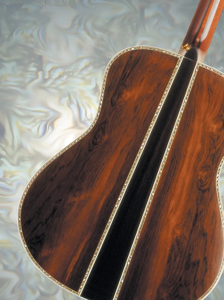 A close-up of the ornate back of John Denver's Yamaha L-53 acoustic guitar.