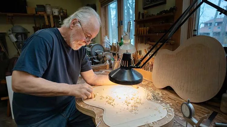 John Monteleone building a guitar at his workbench