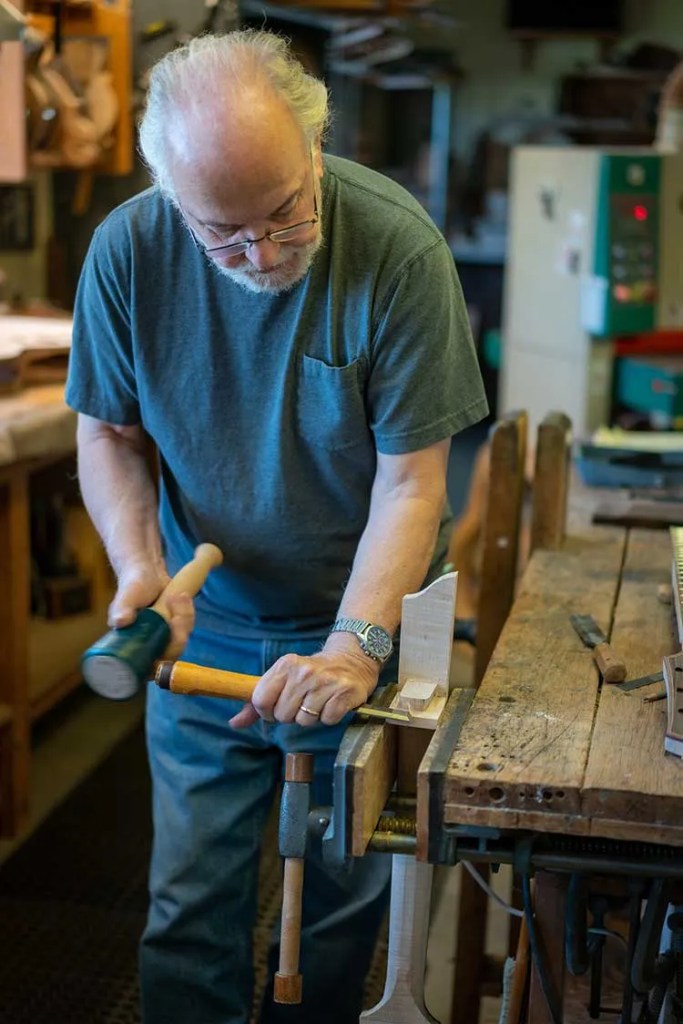 John Monteleone with chisel in his workshop. Photo by Rod-Franklin