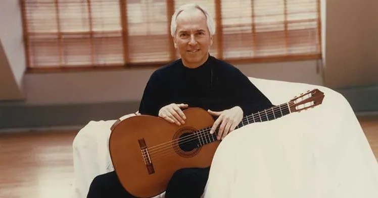 John Williams poses with his guitar