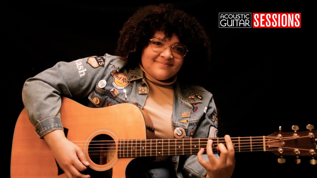 Singer-songwriter Layna seated with acoustic guitar