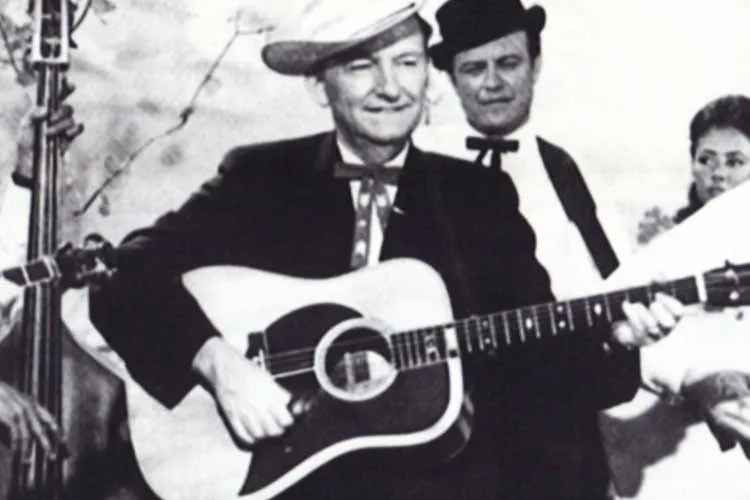 gnutarist Lester Flatt flatpicking with acoustic guitar