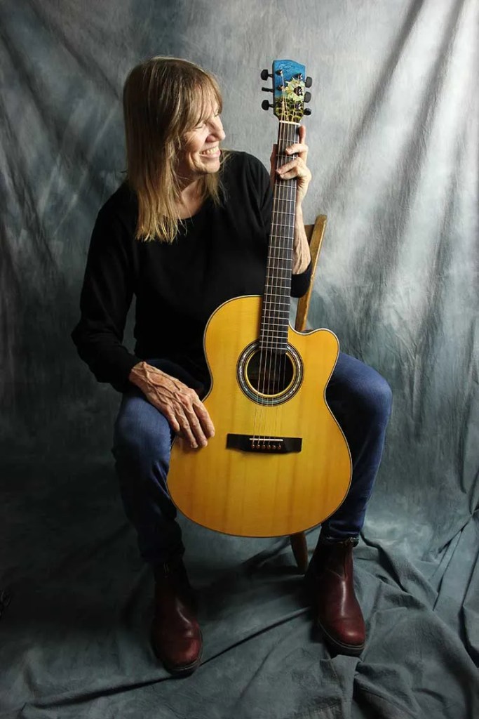 Linda Manzer with her Sunflower Guitar for Ukraine.