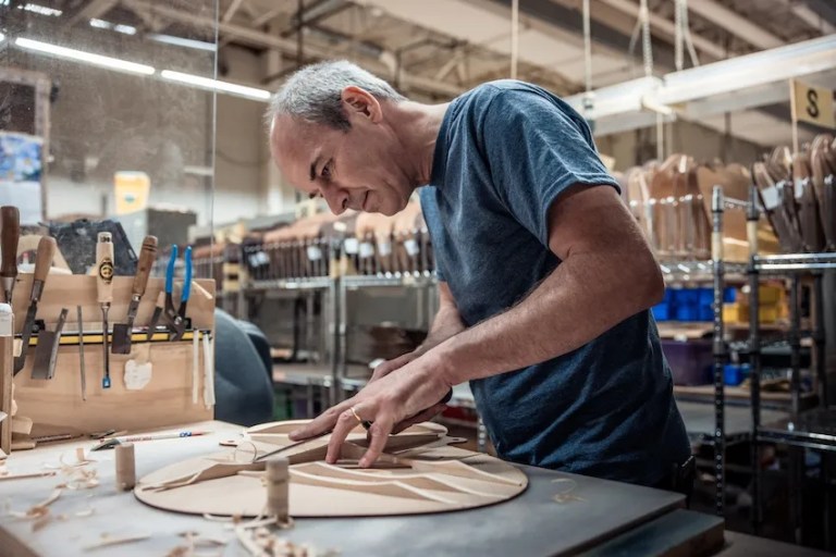 Martin Guitar CEO Thomas Ripsam works on scalloped bracing.