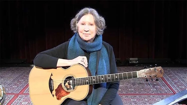 Mary Flower onstage with acoustic guitar