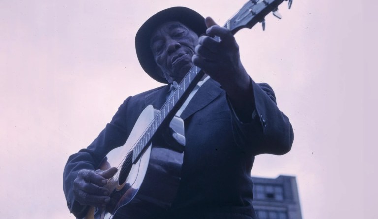 Mississippi John Hurt playing guitar