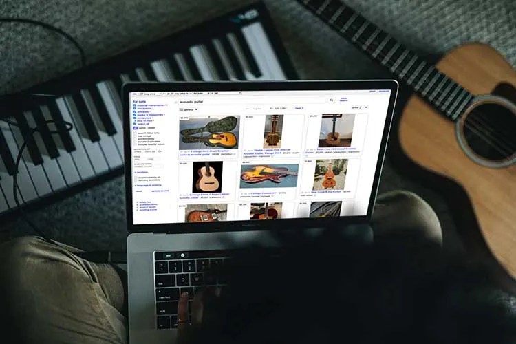 open laptop computer showing a website that sells guitars