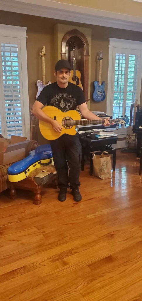 Brad Paisley with Linda Manzer's Sunflower Guitar for Ukraine