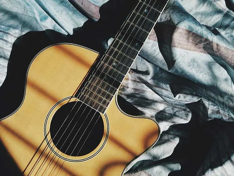 closeup of an acoustic guitar with a cutaway