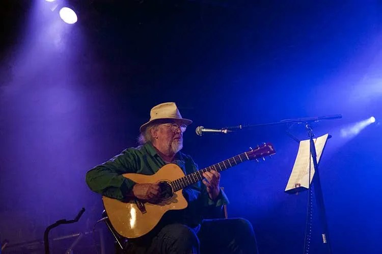 John Renbourn playing guitar onstage