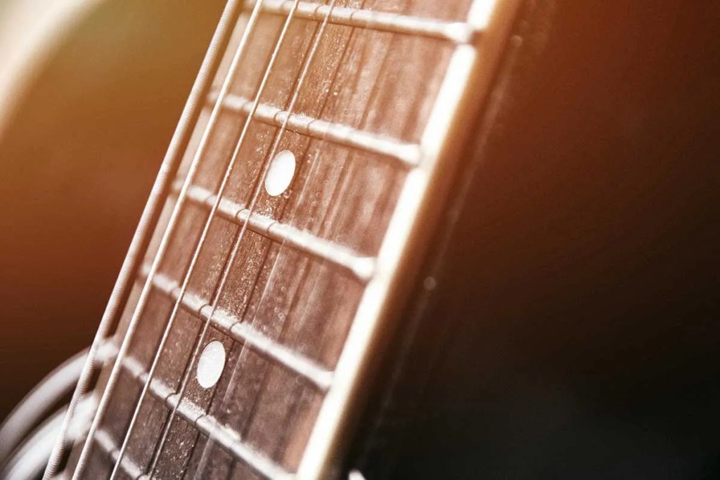 close up of a guitar fretboard