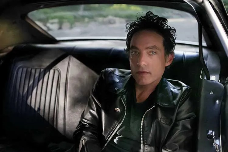 Jakob Dylan sitting in backseat of a car