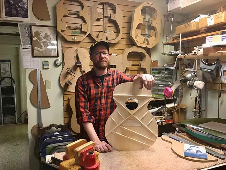 Luthier Raymond Morin hold the top of one of his Pleinview guitars.