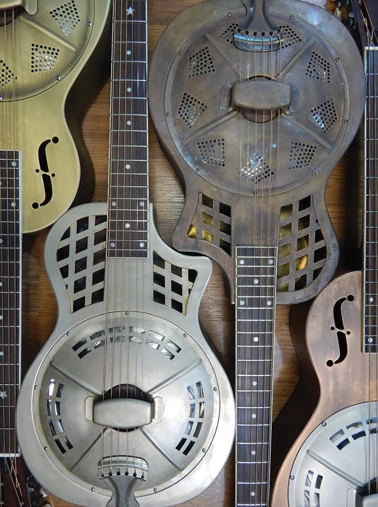 Several resonator guitars arranged in a pattern