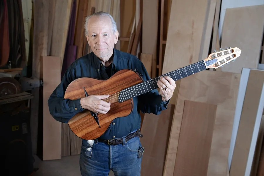 Rick Turner holding one of his guitars