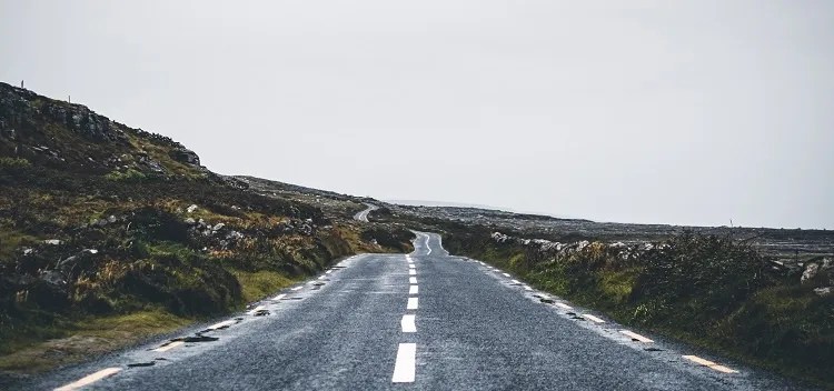 photograph of an asphalt road on a gray day in ireland