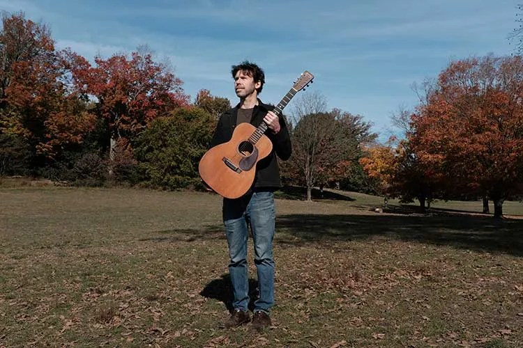 Scott Metzger with acoustic guitar