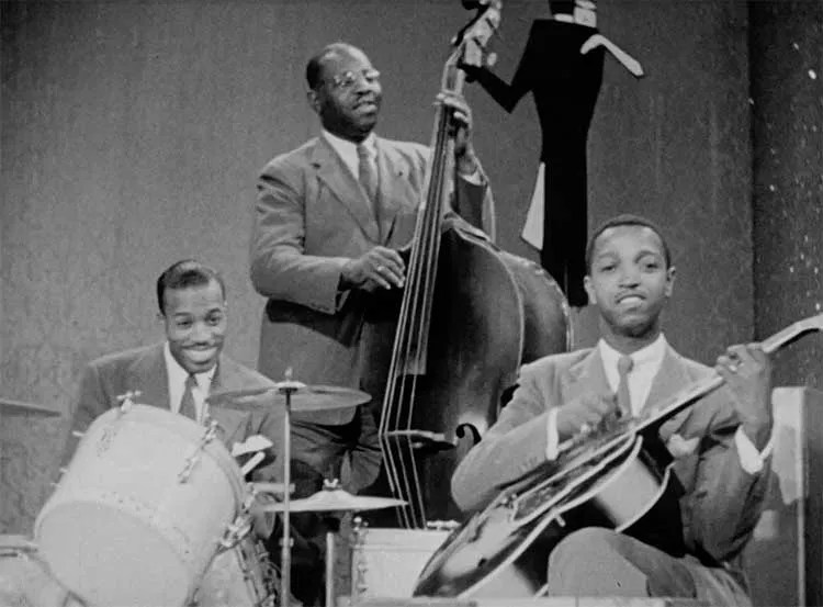 Green with Count Basie Orchestra musicians Jo Jones (drums) and Walter Page.