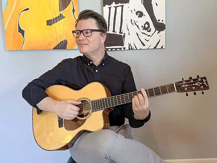 SEAN MCGOWAN playing acoustic guitar