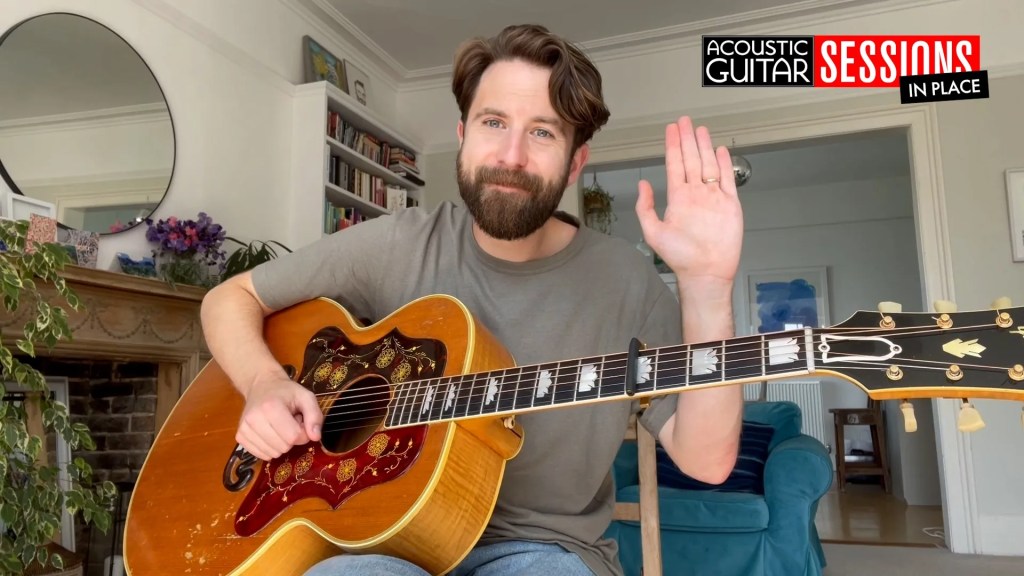 Tom Williams holds his Gibson acoustic guitar in an outtake from his Acoustic Guitar Session in Place