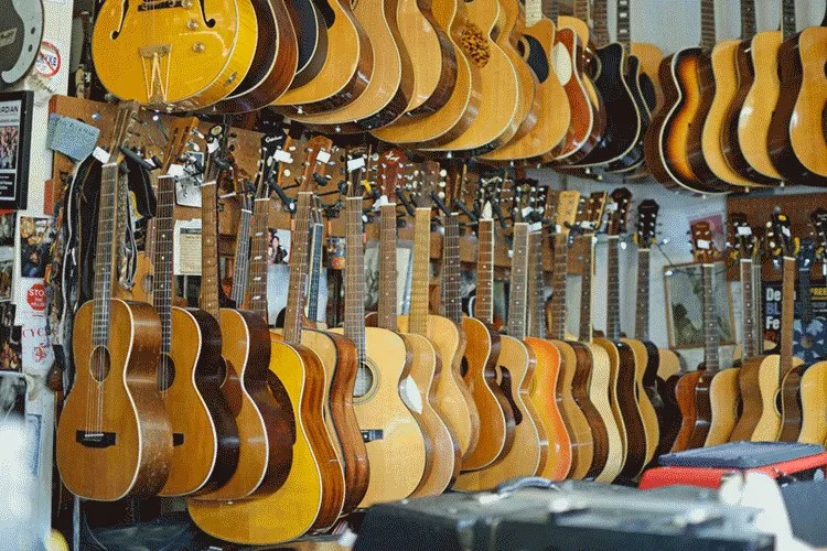 a row of guitars hanging in a shop