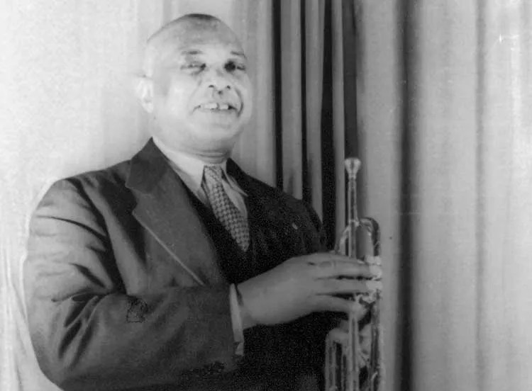 W.C. Handy holding a horn in a 1941 portrait by Carl Van Vechten