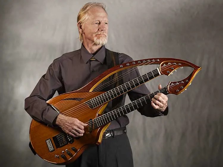 William Eaton with a double neck harp guitar