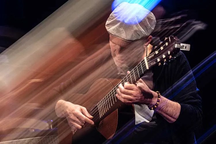 Wolfgang Muthspiel playing a nylon-string acoustic guitar