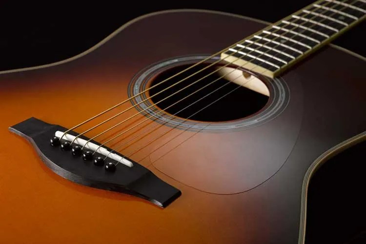 Closeup of Yamaha TransAcoustic dreadnought guitar.